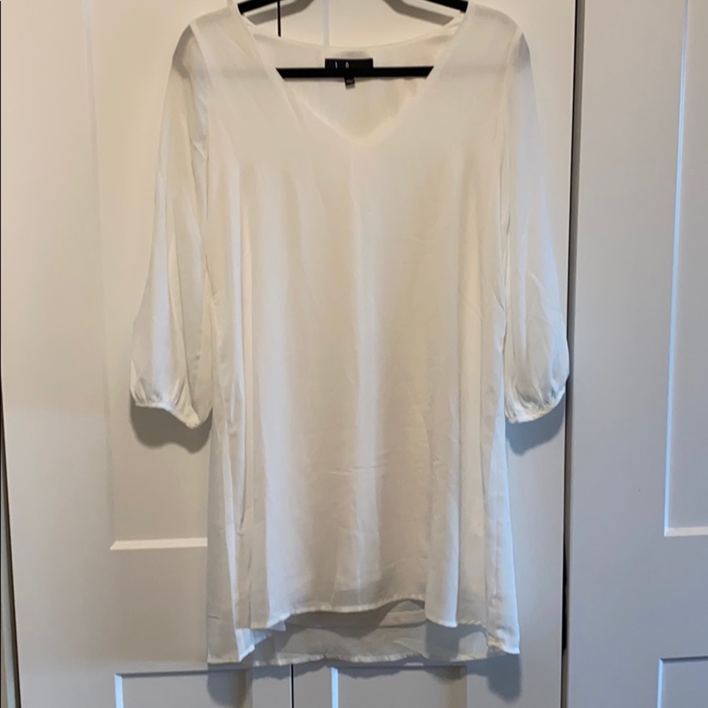 White shift dress with slits in sleeves